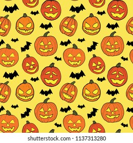 Halloween seamless pattern with orange pumpkins carved faces and black bats on light yellow background. It can be used in design, for cards, wallpapers, textile print, scrapbook digital paper, page fi