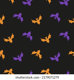 Halloween seamless pattern with purple and orange flying bat silhouettes on a black background