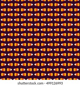 Halloween seamless pattern with small candy corns sweets on dark background. Holiday trick or treat concept. Vector illustration