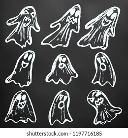 Halloween. Set of ghosts. White chalk on a blackboard. A collection of funny faces. Autumn holidays. Fun, children, traditions