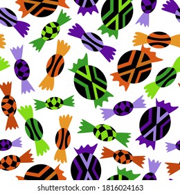 Halloween sweets seamless pattern stock vector illustration. October holiday endless texture with black-green, black-orange and black-violet candies on white background.