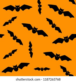 Halloween symbol. Seamless pattern of  flying bats. Black bats on orange background. Silhouette. Cartoon. Vector illustration.