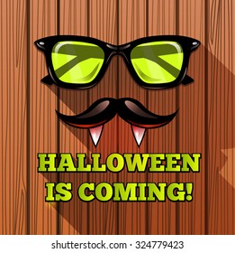 Halloween vampire hipster poster on wooden texture -  vector illustration. Fashionable background with the Vampire hipster sunglasses. Lettering Halloween is coming