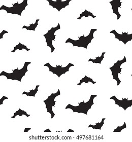 Halloween vector flying black bats silhouettes seamless pattern. Black and white background.