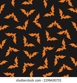Halloween vector seamless background. Repeating pattern with flying orange bats on black background.Ready for printing on textile, fabric, bedding and other seamless surfaces.