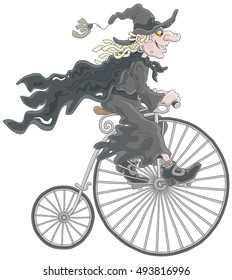 Halloween witch riding an antique bicycle