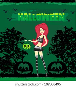 Halloween witch standing with pumpkin