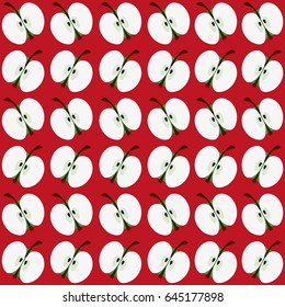 Halves of green apples on a red background. Seamless pattern background