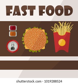 hamburger, french fries, cola and sauces all this fast food on the table