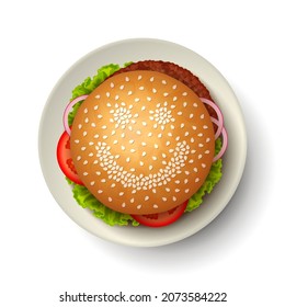 Hamburger with grilled beef, slices of tomato, onion and lettuce on white plate, with happy smiling face made from sesame seeds on bun. Concept of tasty nutritious fast-food, lunch time