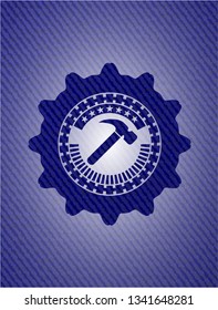 hammer icon inside badge with denim background