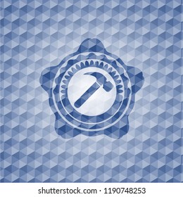 hammer icon inside blue emblem or badge with abstract geometric pattern background.