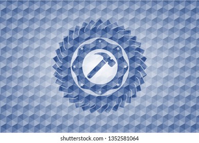 hammer icon inside blue emblem with geometric background.