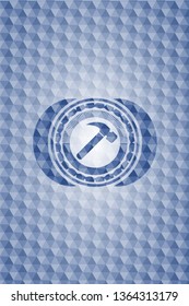 hammer icon inside blue polygonal emblem.