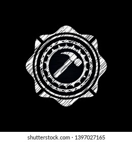 hammer icon inside chalkboard emblem on black board