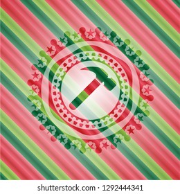 hammer icon inside christmas colors style badge.