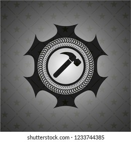 hammer icon inside dark emblem