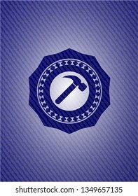 hammer icon inside denim background