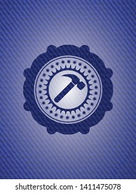 hammer icon inside emblem with denim texture
