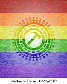 hammer icon inside emblem on mosaic background with the colors of the LGBT flag