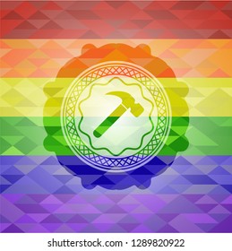 hammer icon inside emblem on mosaic background with the colors of the LGBT flag