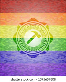 hammer icon inside emblem on mosaic background with the colors of the LGBT flag