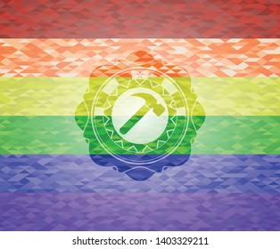 hammer icon inside emblem on mosaic background with the colors of the LGBT flag