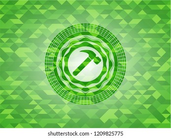hammer icon inside green emblem with mosaic background