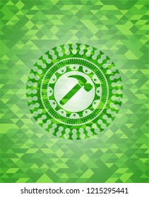 hammer icon inside green mosaic emblem