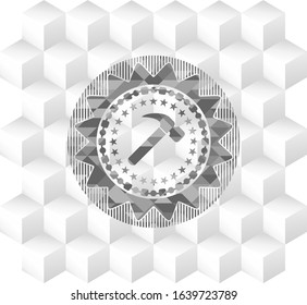 hammer icon inside grey badge with geometric cube white background