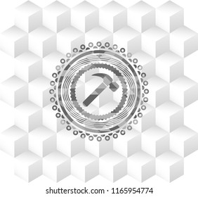 hammer icon inside grey emblem with geometric cube white background