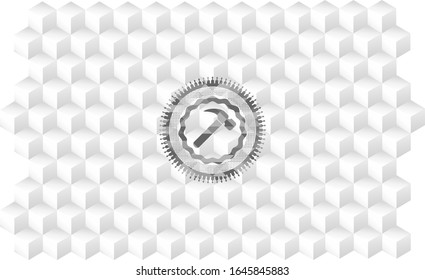 hammer icon inside grey icon or emblem with geometric cube white background