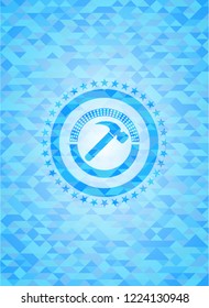 hammer icon inside light blue emblem with triangle mosaic background