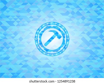 hammer icon inside light blue emblem with triangle mosaic background