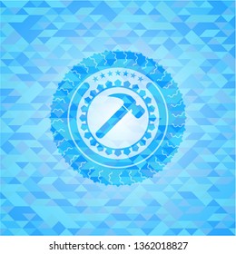 hammer icon inside light blue emblem with mosaic ecological style background