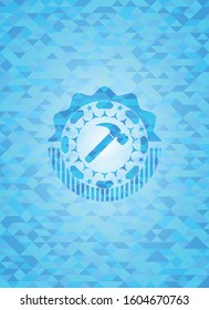 hammer icon inside light blue emblem with triangle mosaic background