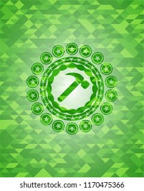 hammer icon inside realistic green mosaic emblem