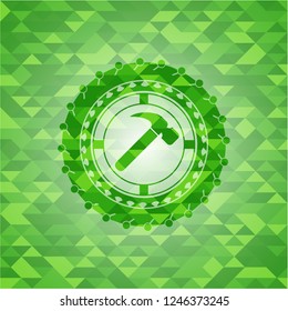 hammer icon inside realistic green mosaic emblem
