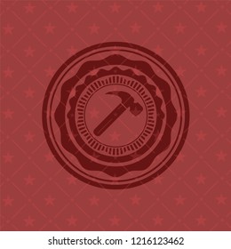 hammer icon inside red emblem