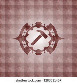 hammer icon inside red seamless emblem with geometric pattern.