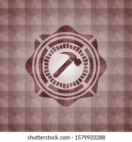 hammer icon inside red seamless badge with geometric pattern.