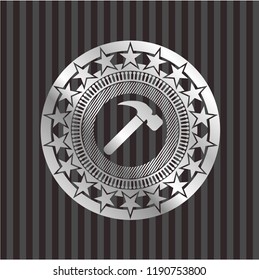 hammer icon inside silver emblem or badge