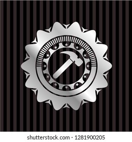 hammer icon inside silver emblem
