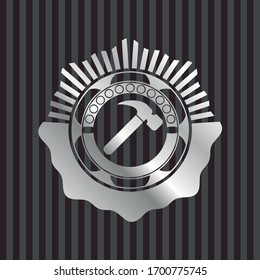 hammer icon inside silver emblem or badge
