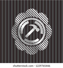 hammer icon inside silvery badge or emblem