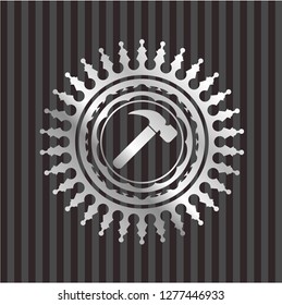 hammer icon inside silvery emblem or badge