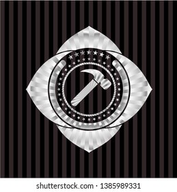 hammer icon inside silvery emblem or badge