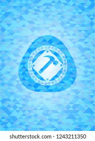 hammer icon inside sky blue emblem with triangle mosaic background