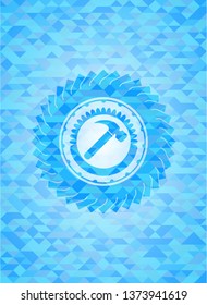 hammer icon inside sky blue emblem with triangle mosaic background