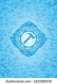 hammer icon inside sky blue emblem with mosaic background